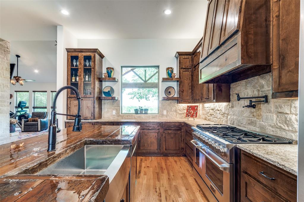 626 Lone Tree Road Nevada, TX 75173 - Photo 7 of 40 a kitchen with stainless steel appliances granite countertop a stove and a sink