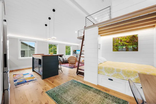 a bedroom with furniture and a flat screen tv