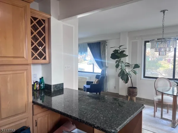 a kitchen view with dining table stainless steel appliances and windows