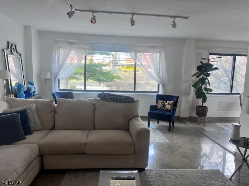 1375 River Road, Unit 2K Edgewater, NJ 07020 - Photo 7 of 13 a living room with furniture and a large window