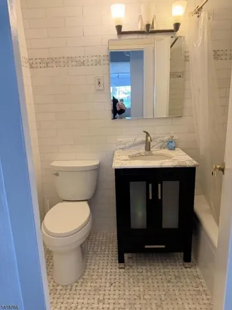 a bathroom with a sink a toilet and a mirror