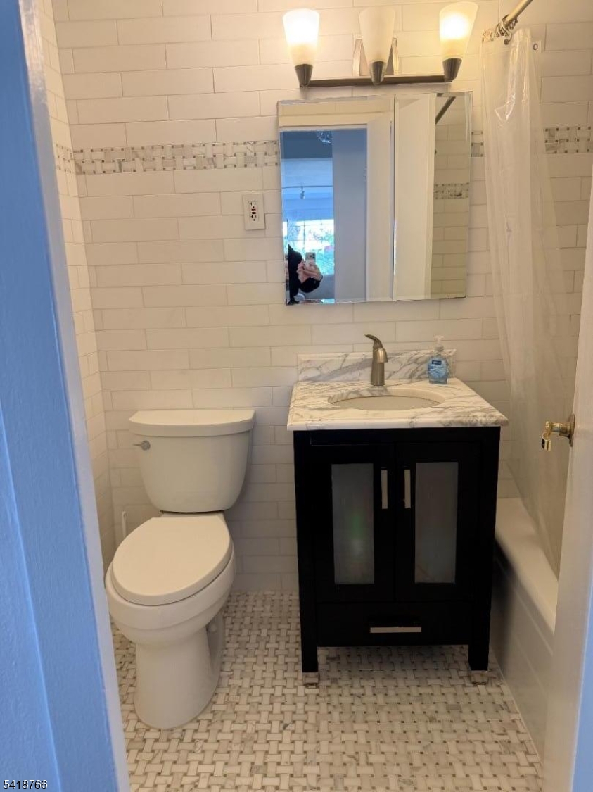 1375 River Road, Unit 2K Edgewater, NJ 07020 - Photo 8 of 13 a bathroom with a sink a toilet and a mirror