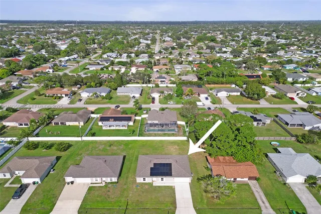 an aerial view of residential houses with outdoor space and street view