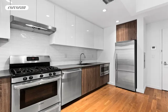 a kitchen with stainless steel appliances granite countertop a stove a refrigerator and a microwave