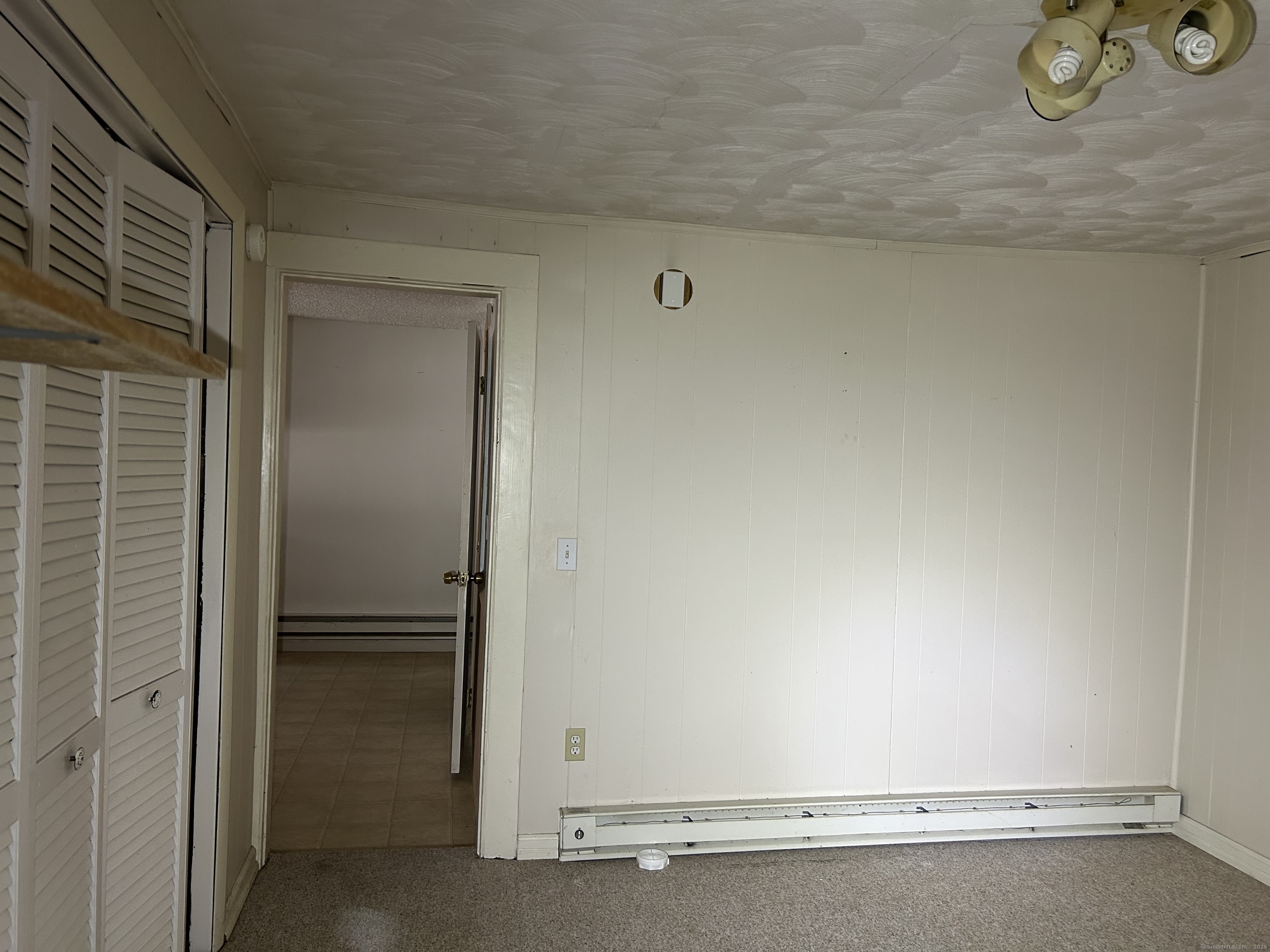 47 Gilbert Street, Unit 1 Derby, CT 06418 - Photo 20 of 21 a room with a bench