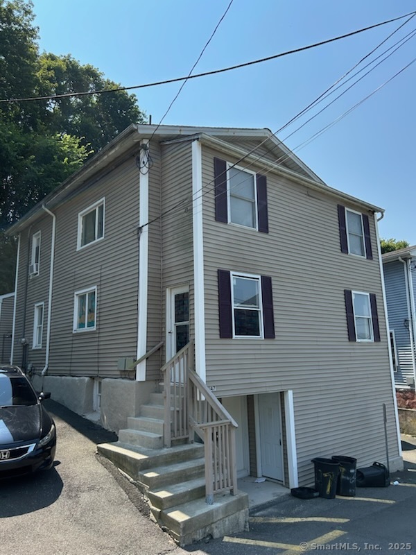 47 Gilbert Street, Unit 1 Derby, CT 06418 - Photo 4 of 21 a house that has a lot of windows on it