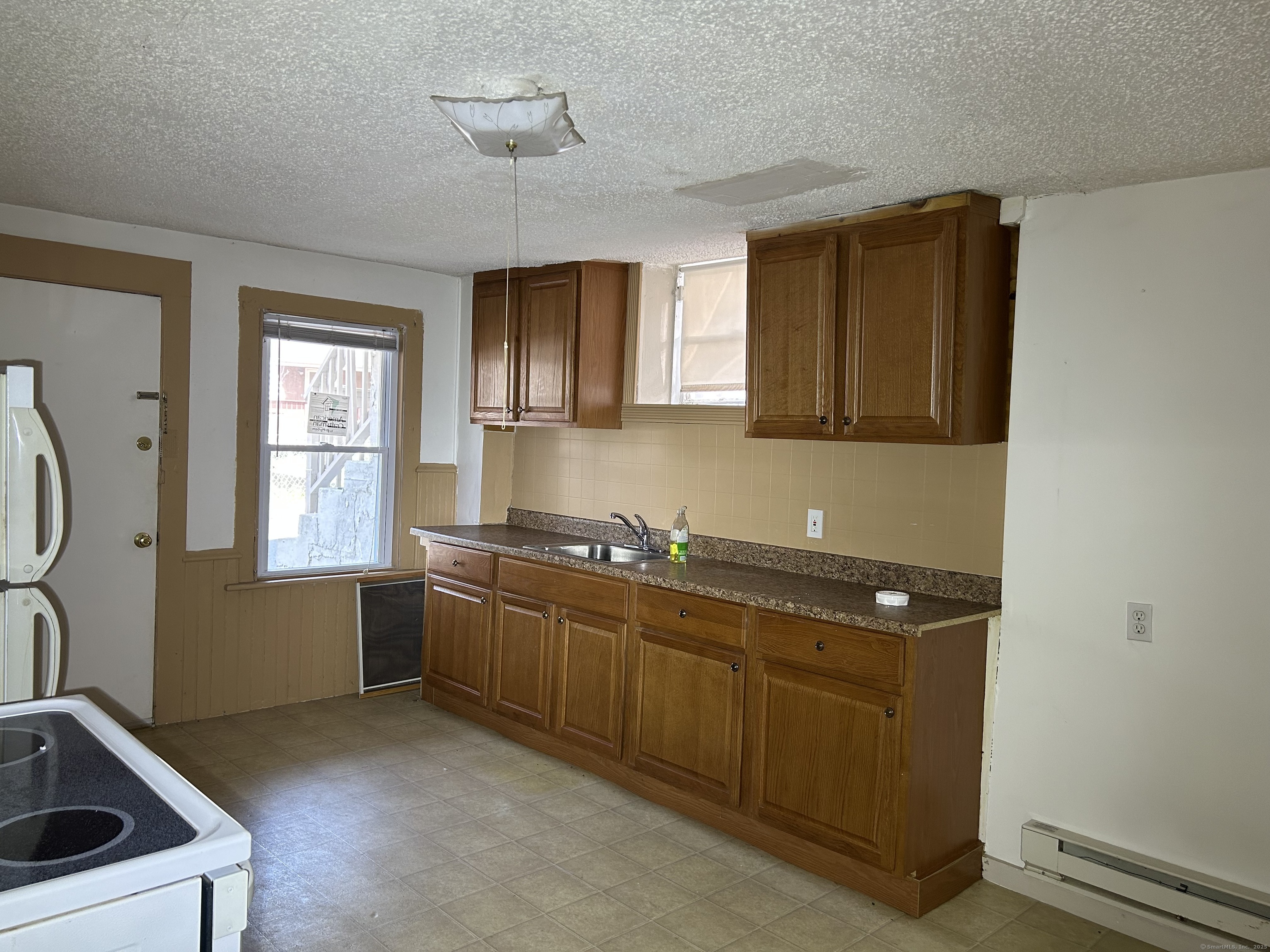 47 Gilbert Street, Unit 1 Derby, CT 06418 - Photo 6 of 21 a kitchen with stainless steel appliances granite countertop a sink and a stove