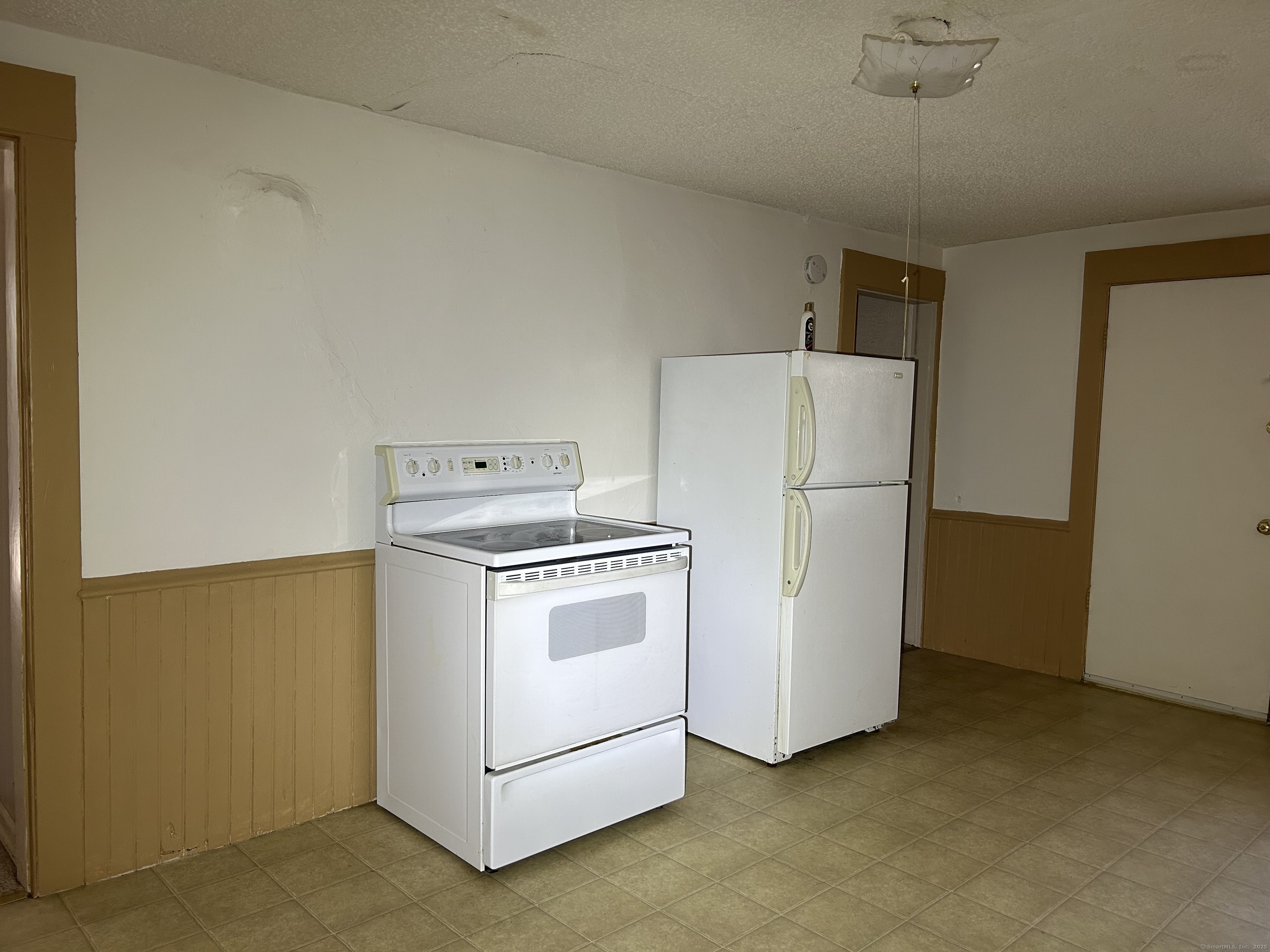 47 Gilbert Street, Unit 1 Derby, CT 06418 - Photo 7 of 21 a white refrigerator freezer and a stove sitting inside of a kitchen