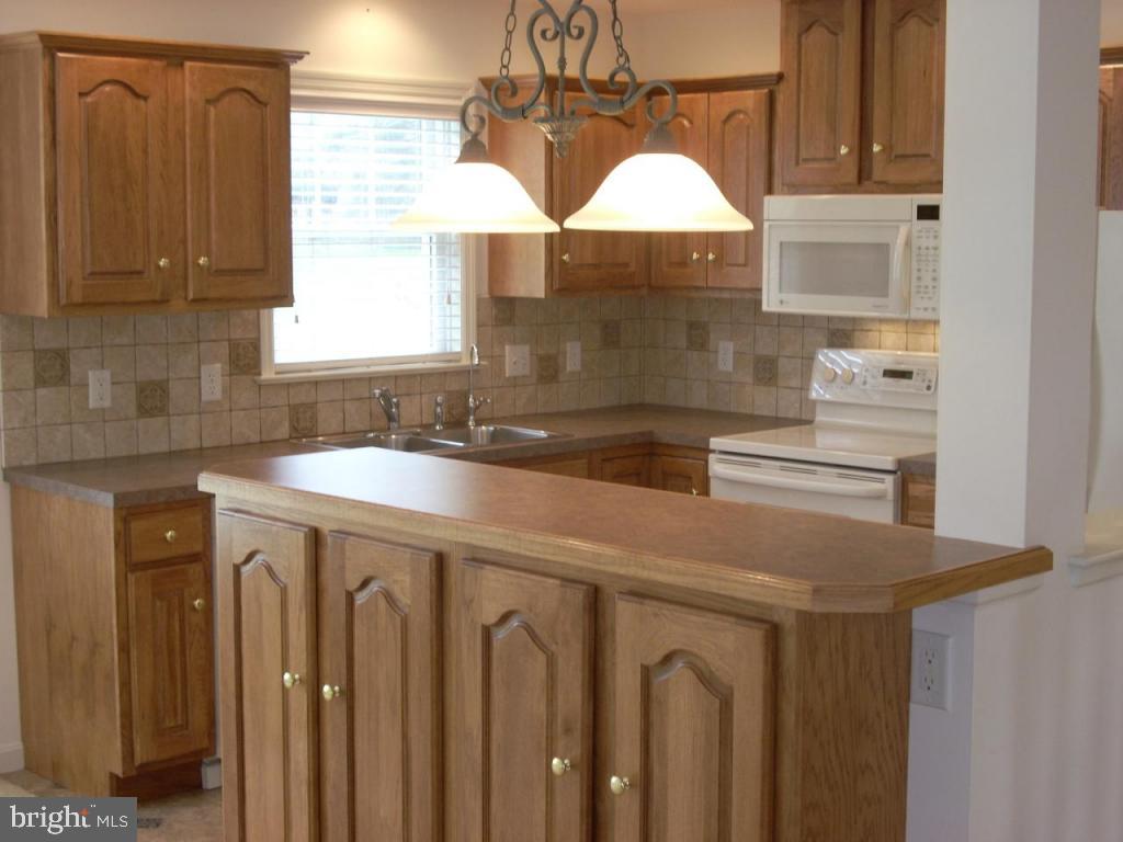 548 Wallingford Road Lancaster, PA 17601 - Photo 5 of 12 a kitchen with stainless steel appliances a sink a stove and a window