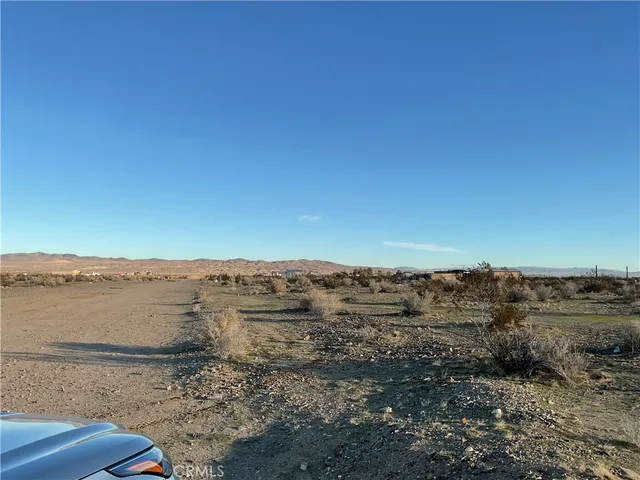 a view of an ocean beach and mountain