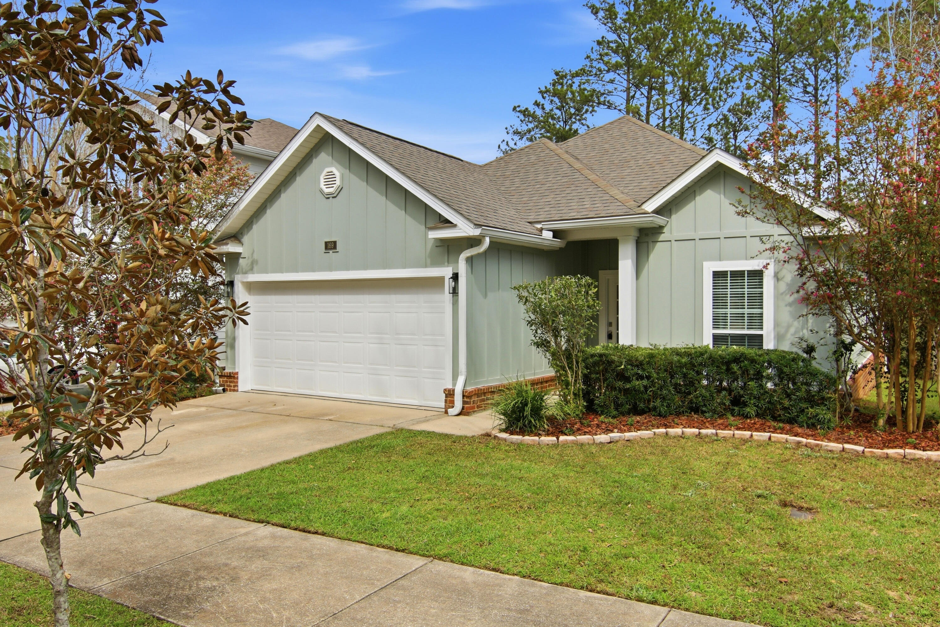 169 Marsh Landing North Freeport, FL 32439 - Photo 2 of 44 a view of a house with a yard and potted plants