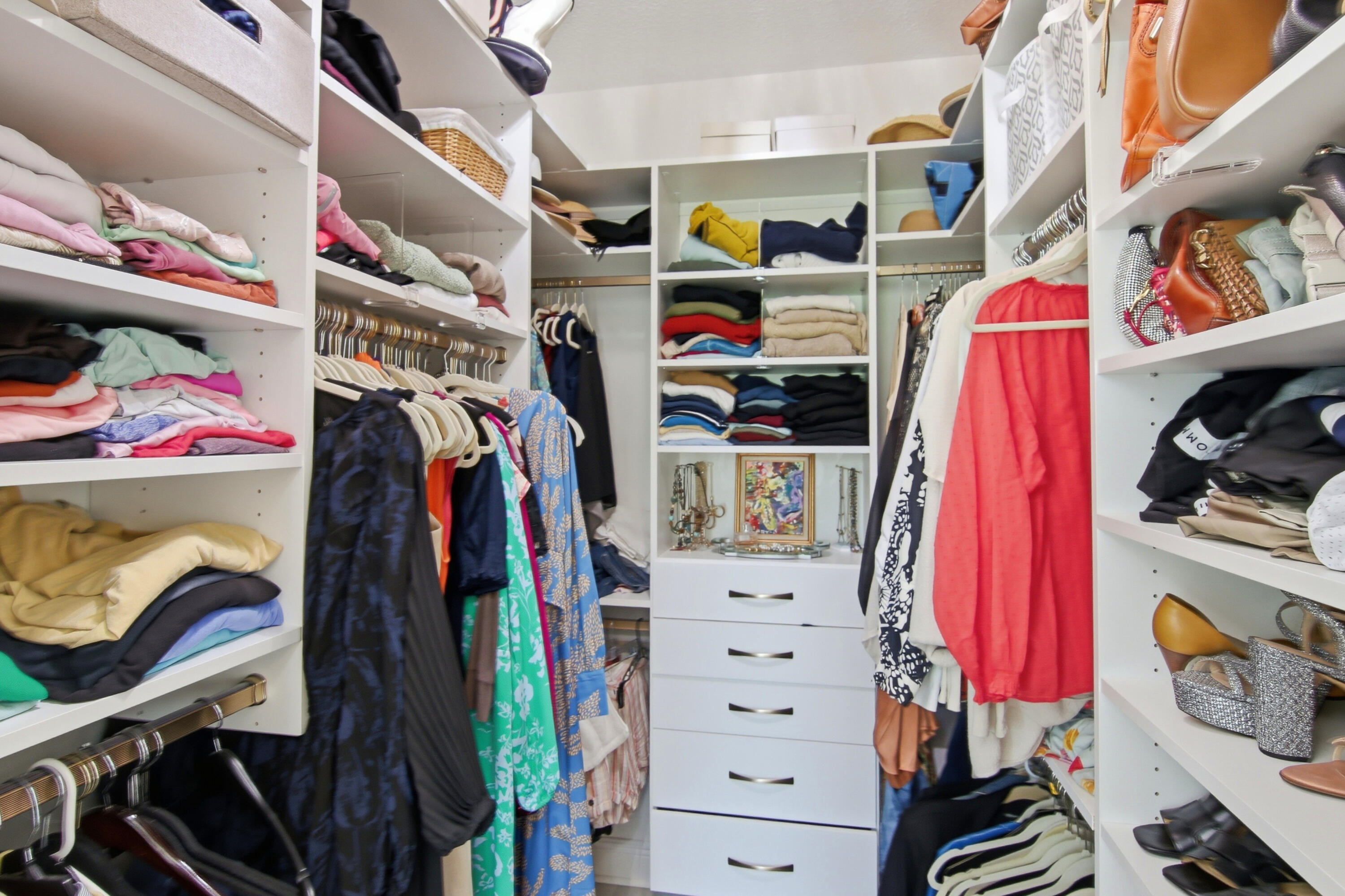 169 Marsh Landing North Freeport, FL 32439 - Photo 21 of 44 a view of walk in closet with clothes and shoes