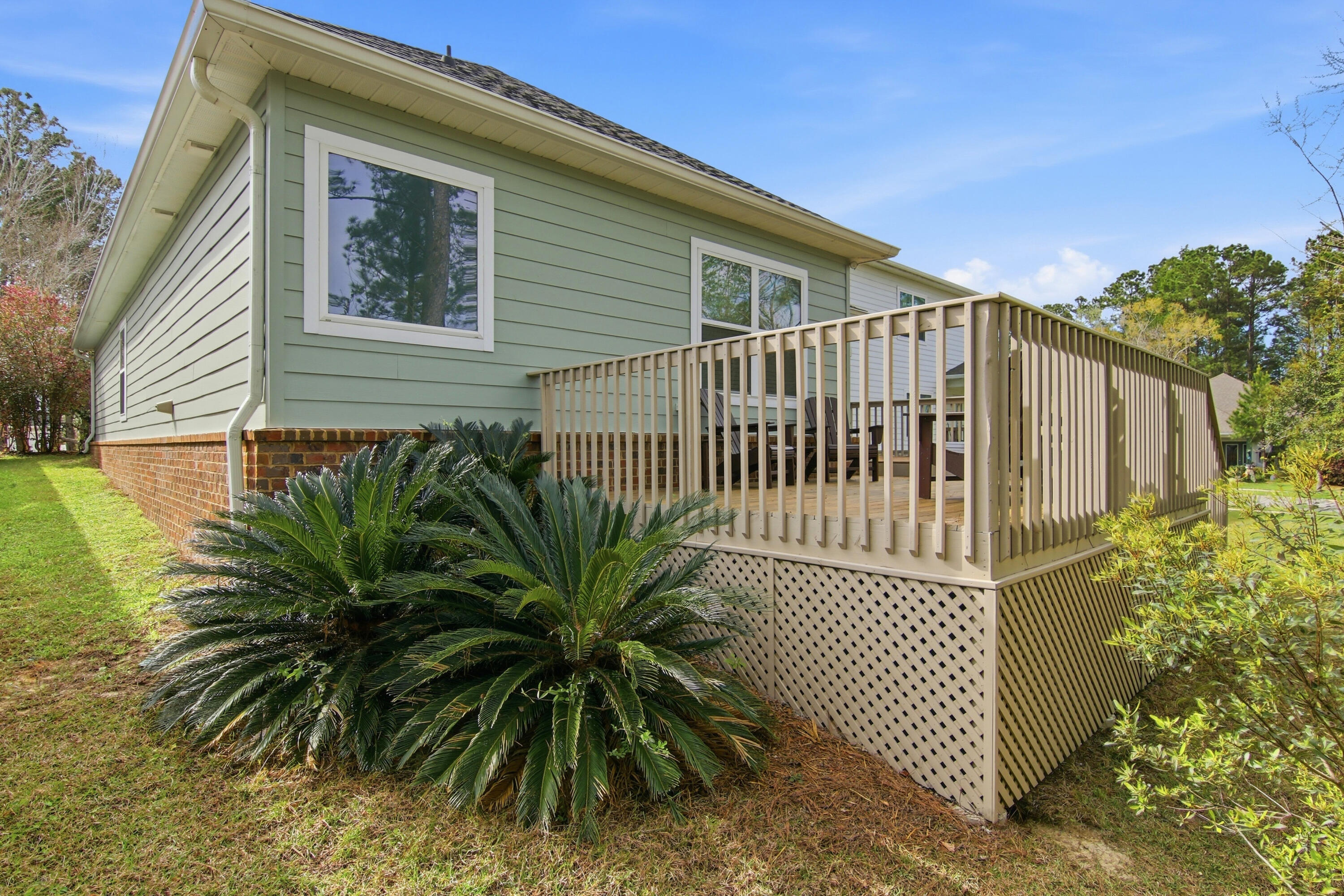 169 Marsh Landing North Freeport, FL 32439 - Photo 35 of 44 a view of a house with a small yard and floor to ceiling window