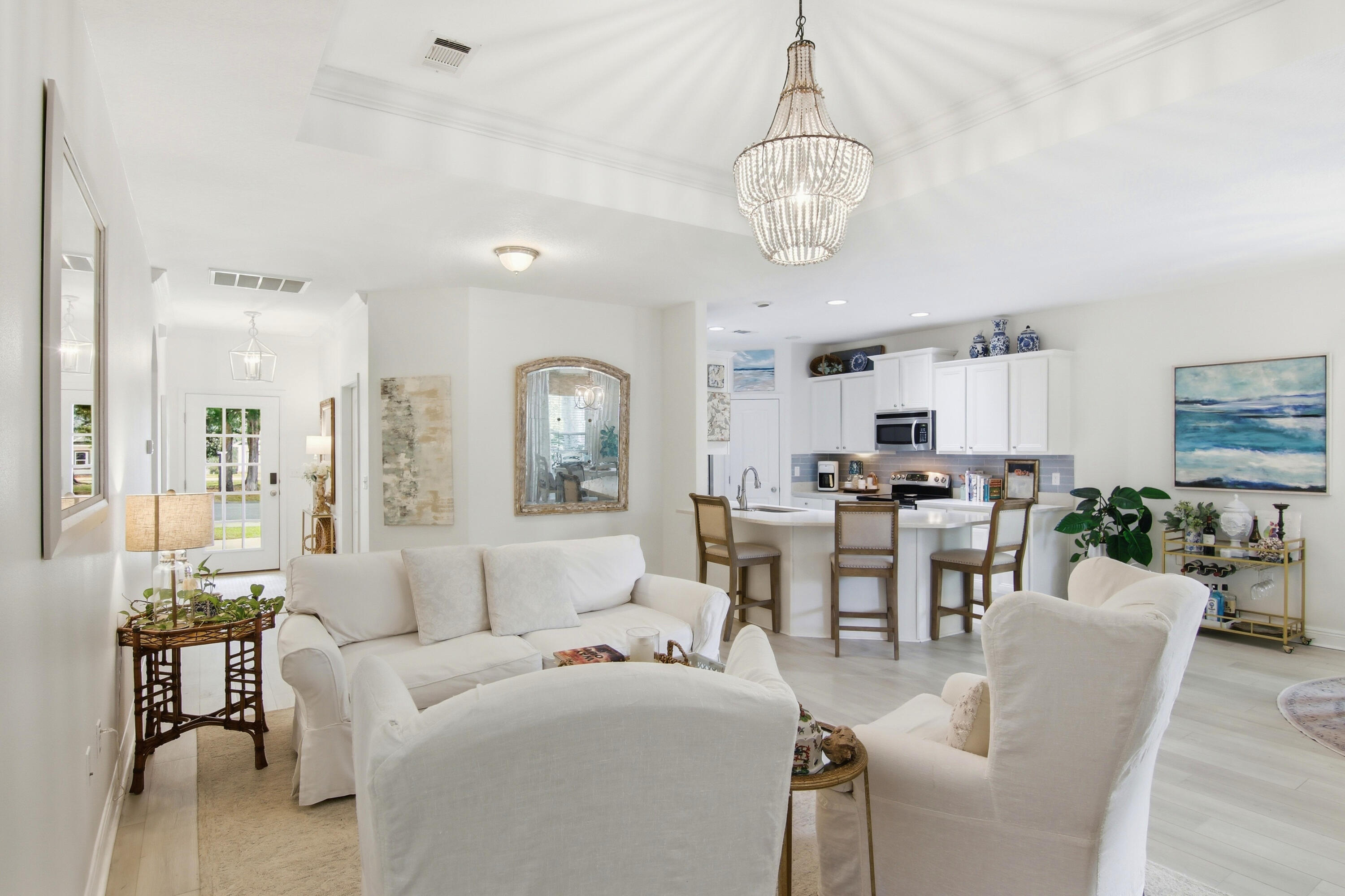 169 Marsh Landing North Freeport, FL 32439 - Photo 8 of 44 a living room with furniture kitchen view and a chandelier