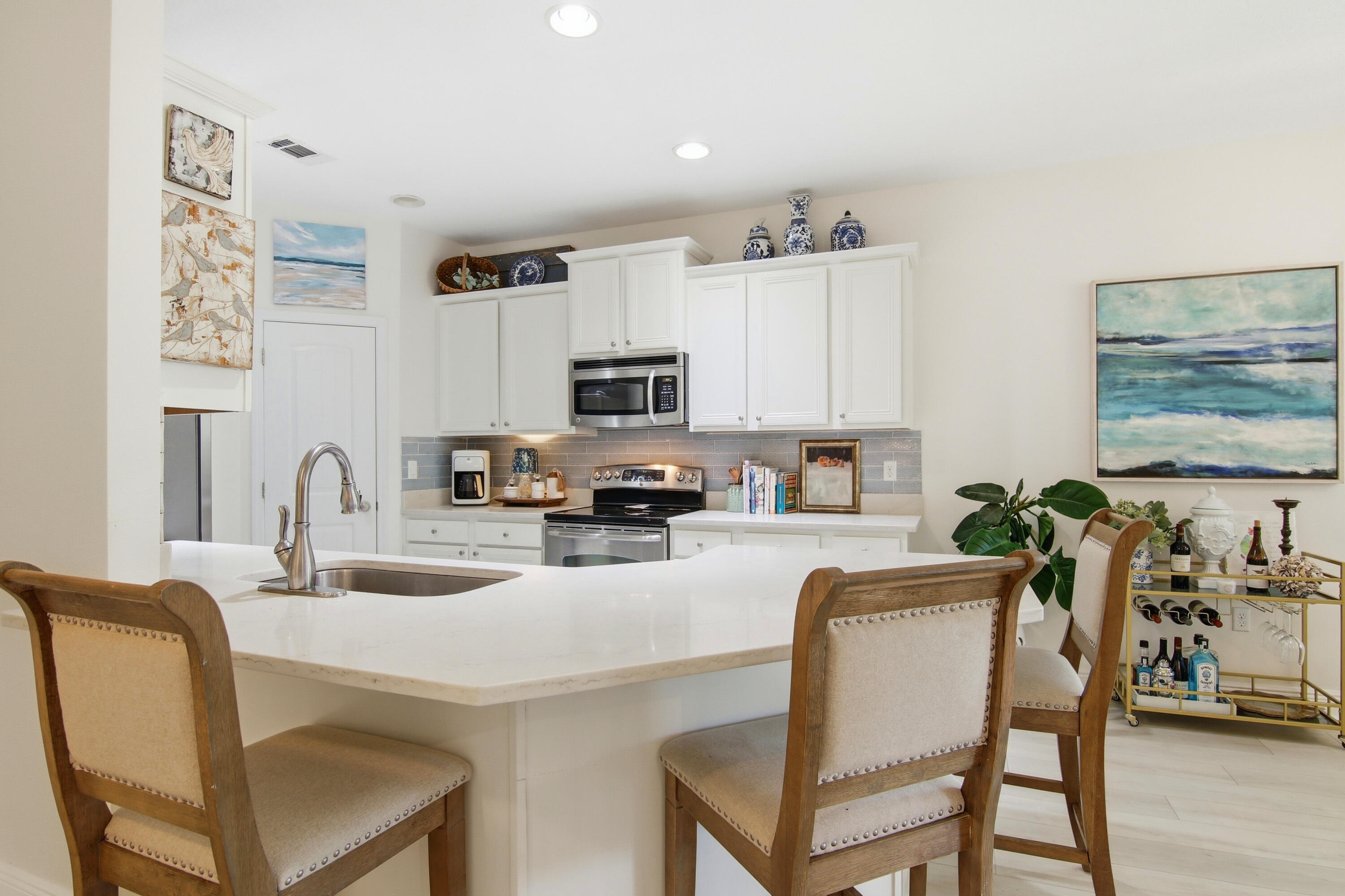 169 Marsh Landing North Freeport, FL 32439 - Photo 10 of 44 a kitchen with white cabinets and chairs