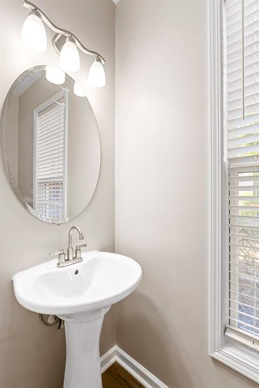 473 Greyhawk Way Fairburn, GA 30213 - Photo 16 of 34 a bathroom with a sink a mirror and a window