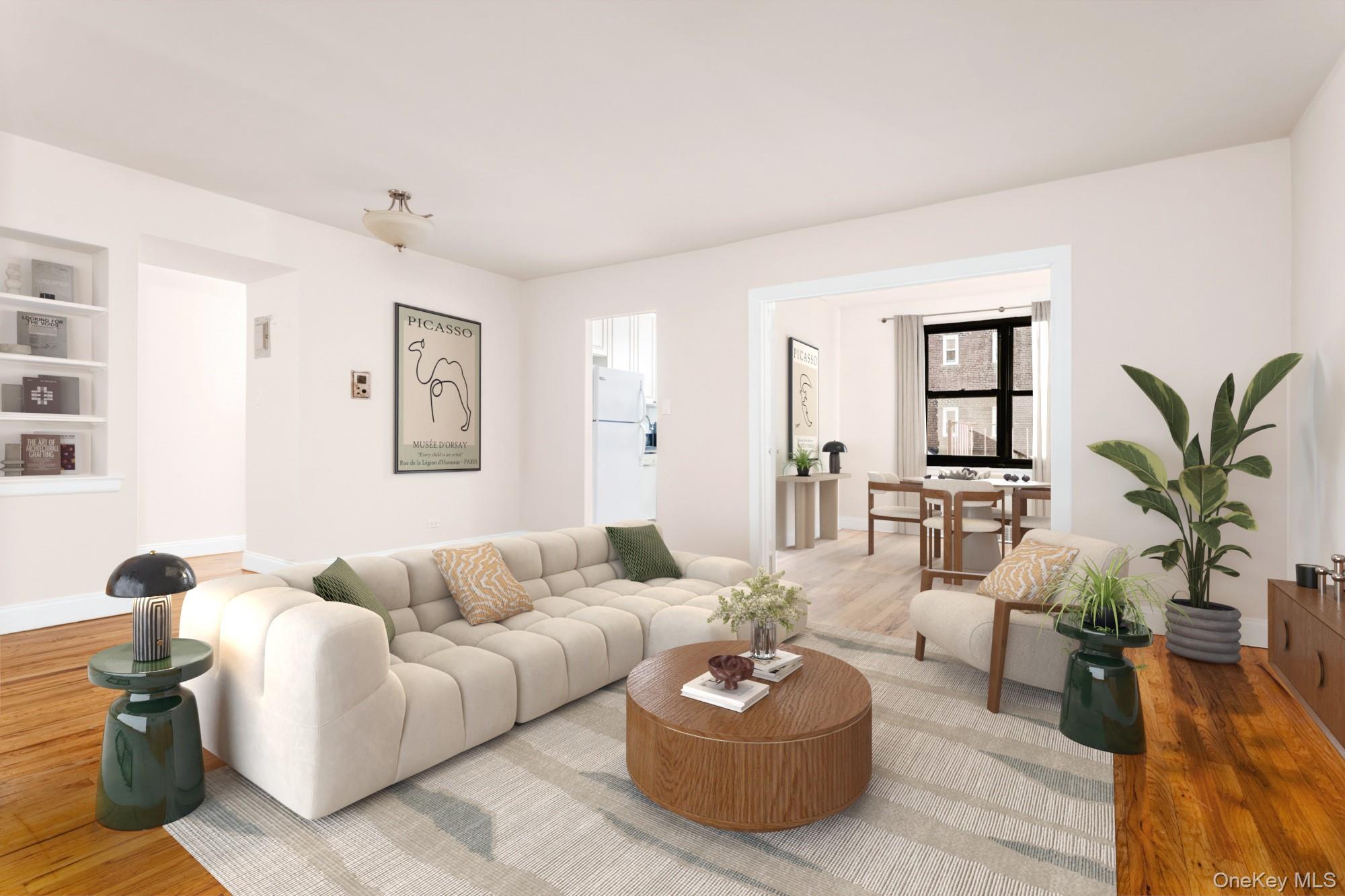 100-11 67th Road, Unit 205 Forest Hills, NY 11375 - Photo 2 of 15 a living room with furniture and a potted plant