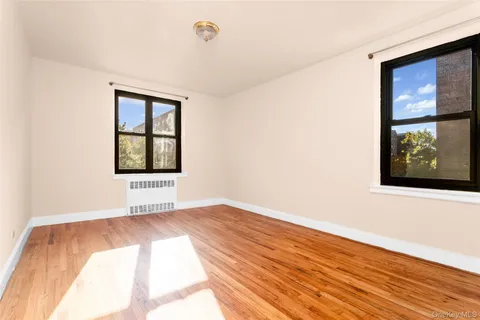 a bedroom with a bed and a potted plant
