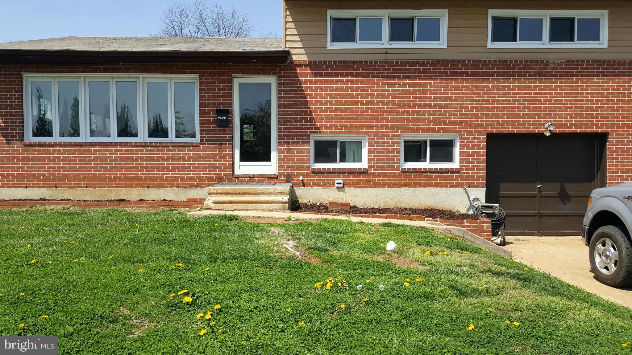 1008 Collwood Road Catonsville, MD 21228 - Photo 1 of 25 a front view of a house with a garden