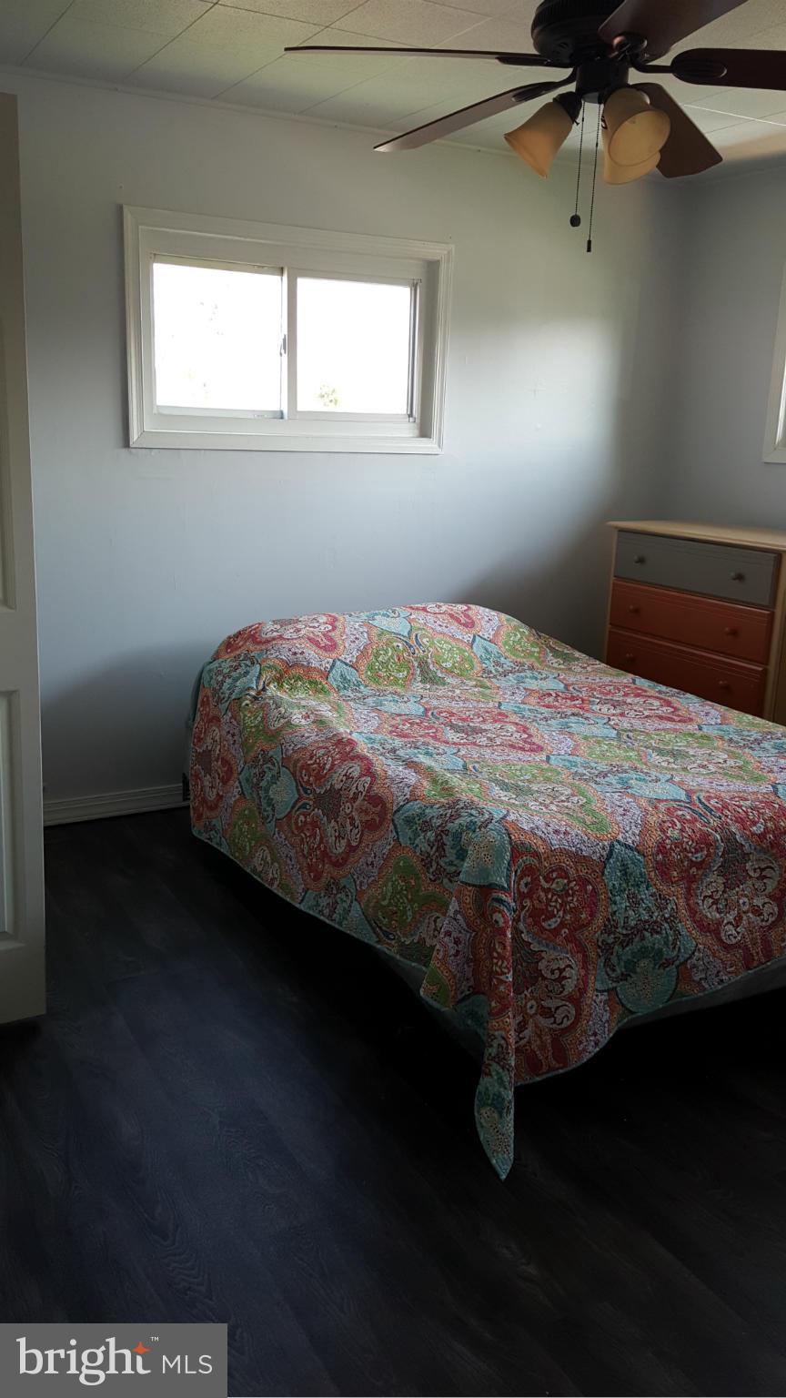1008 Collwood Road Catonsville, MD 21228 - Photo 14 of 25 a bed sitting in a bedroom next to a window