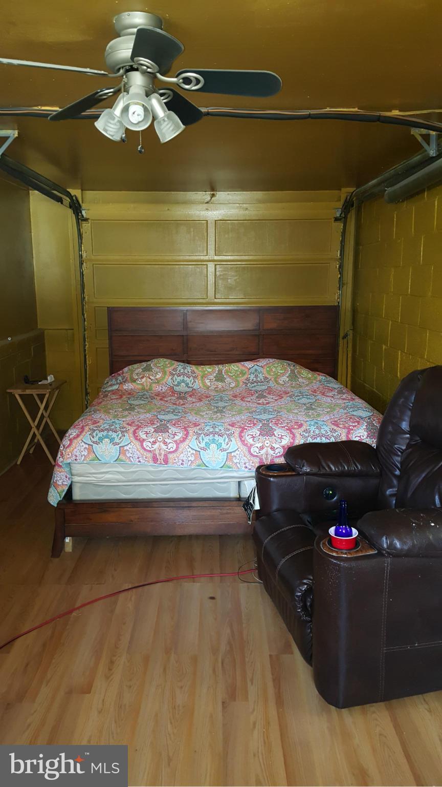 1008 Collwood Road Catonsville, MD 21228 - Photo 23 of 25 a bedroom with a bed window and a chandelier