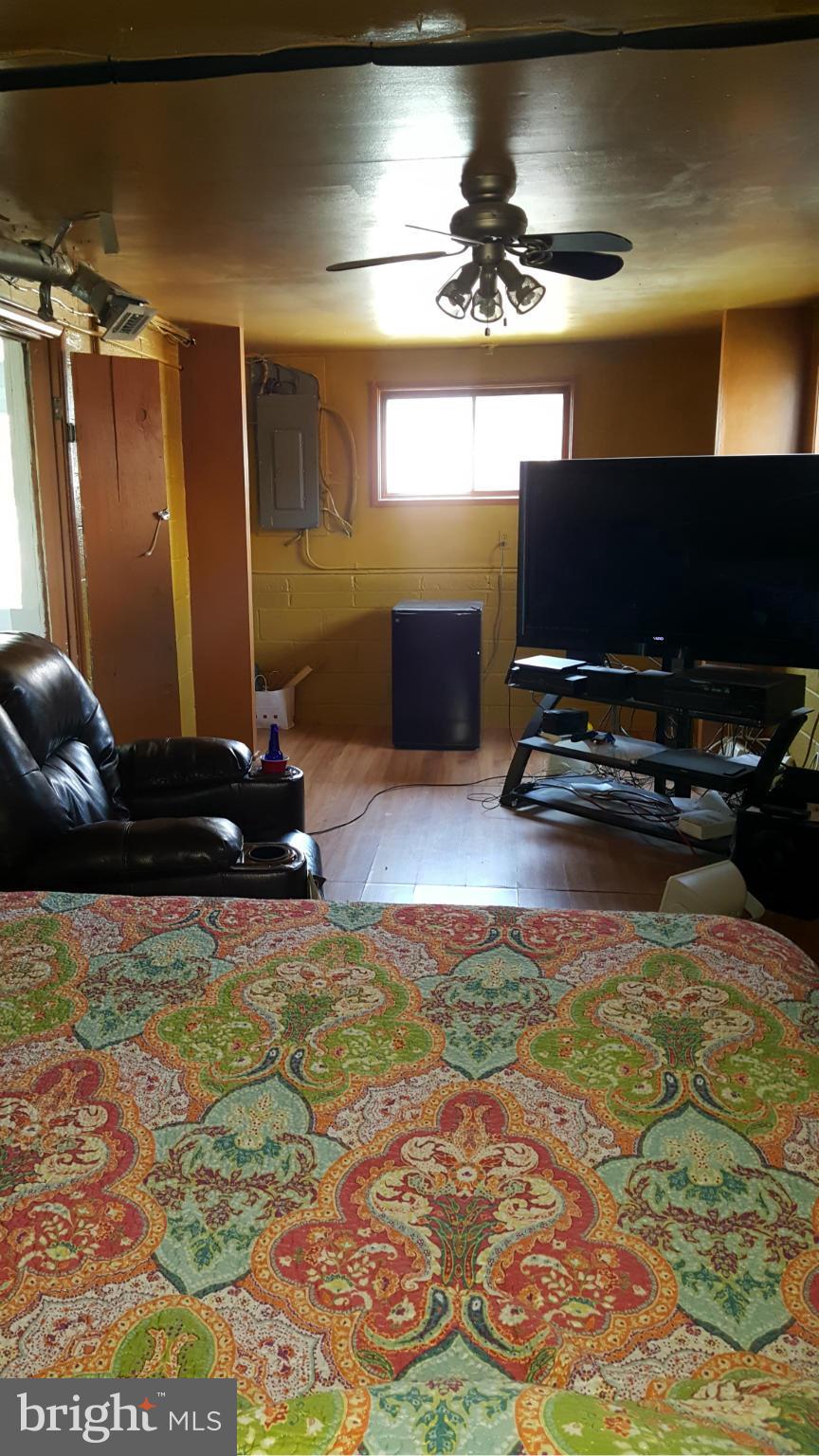 1008 Collwood Road Catonsville, MD 21228 - Photo 24 of 25 a living room with projector and a flat screen tv
