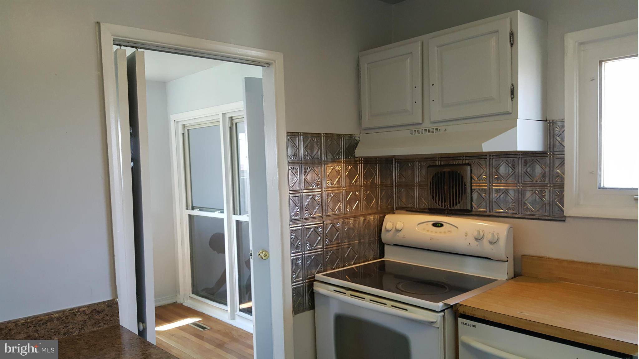 1008 Collwood Road Catonsville, MD 21228 - Photo 4 of 25 a kitchen with a stove and a refrigerator