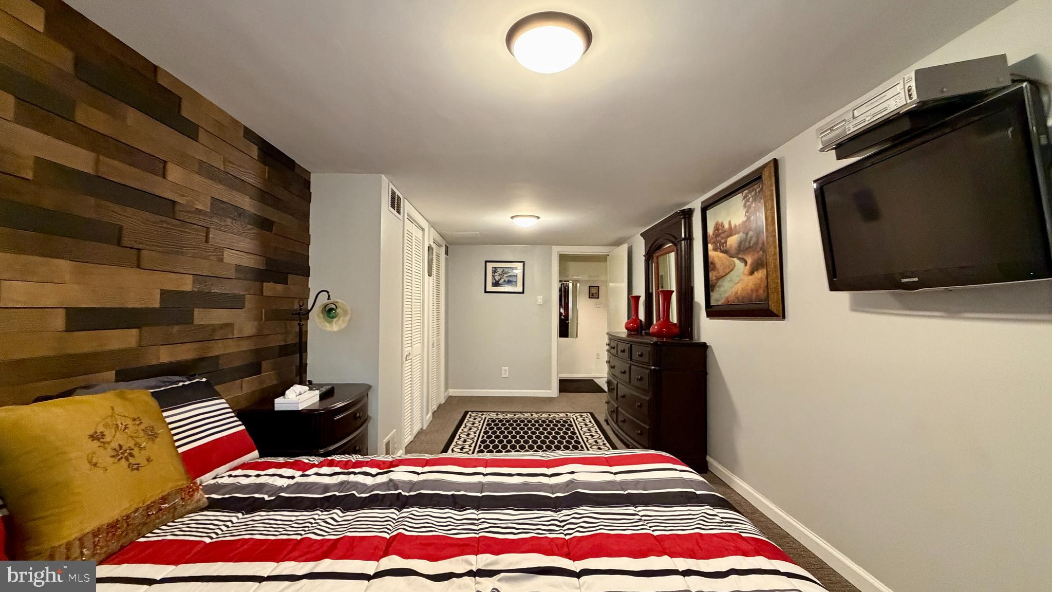 1829 Tomlinson Road Philadelphia, PA 19116 - Photo 12 of 15 a bedroom with a bed and a flat screen tv