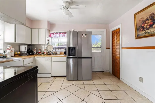 a kitchen with a refrigerator a sink dishwasher and cabinets