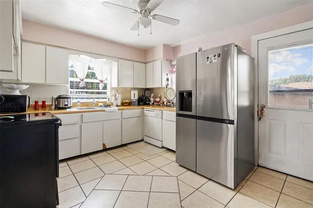 a kitchen with a refrigerator a sink and cabinets