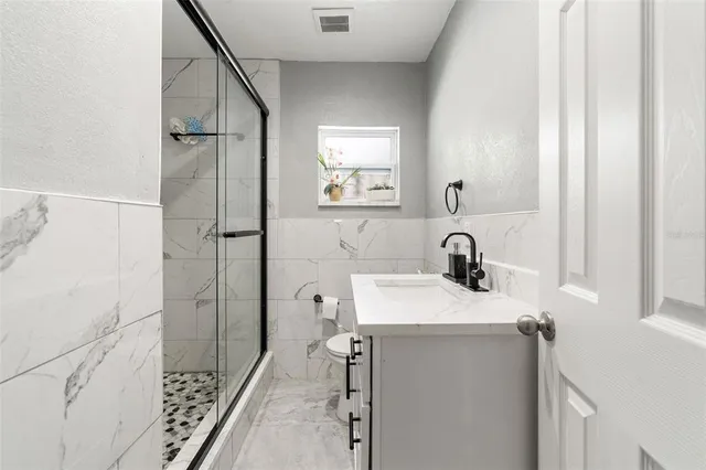 a bathroom with a sink a toilet and a mirror