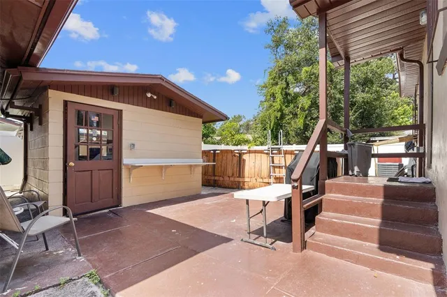 a balcony with furniture and a potted plant