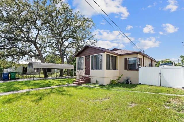 a front view of a house with a yard table and chairs