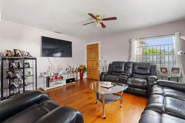 a living room with furniture and a flat screen tv