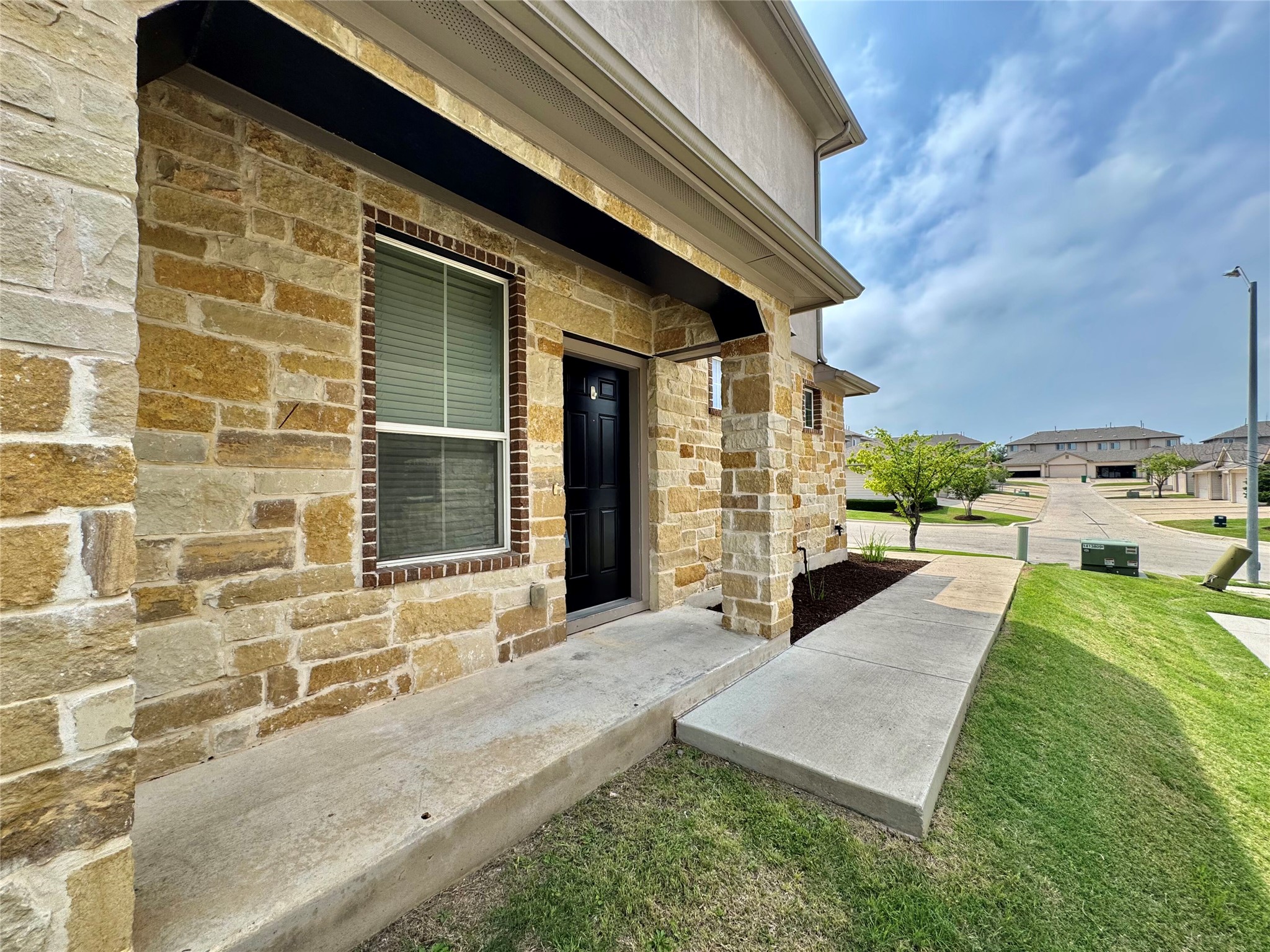 407 Rhetoric Way Pflugerville, TX 78660 - Photo 4 of 38 a view of a patio with table and chairs and potted plants