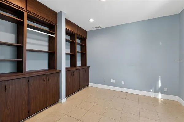 a view of an empty room with a fireplace and a window