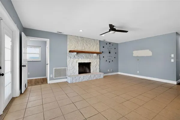a view of a livingroom with a fireplace and window