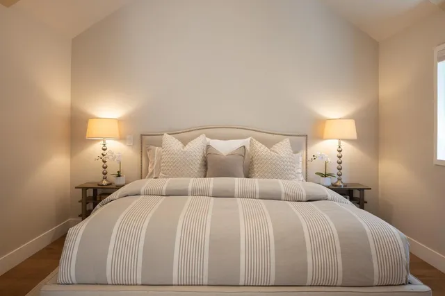 a bedroom with a bed and a lamp