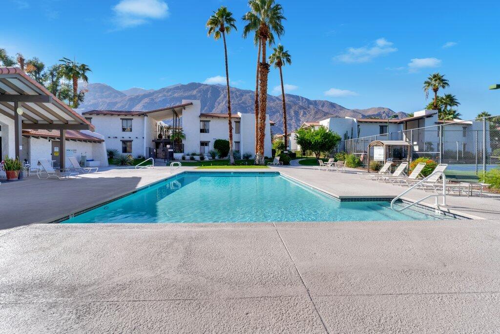 1050 Ramon Road, Unit 3 Palm Springs, CA 92264 - Photo 27 of 28 a house with a yard and potted plants