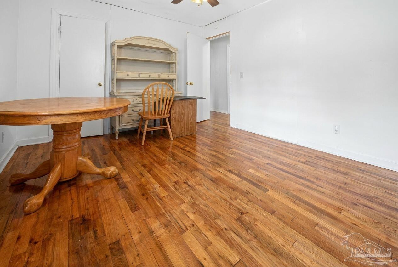 6253 Allentown Road Milton, FL 32570 - Photo 9 of 31 a room with wooden floor and a table