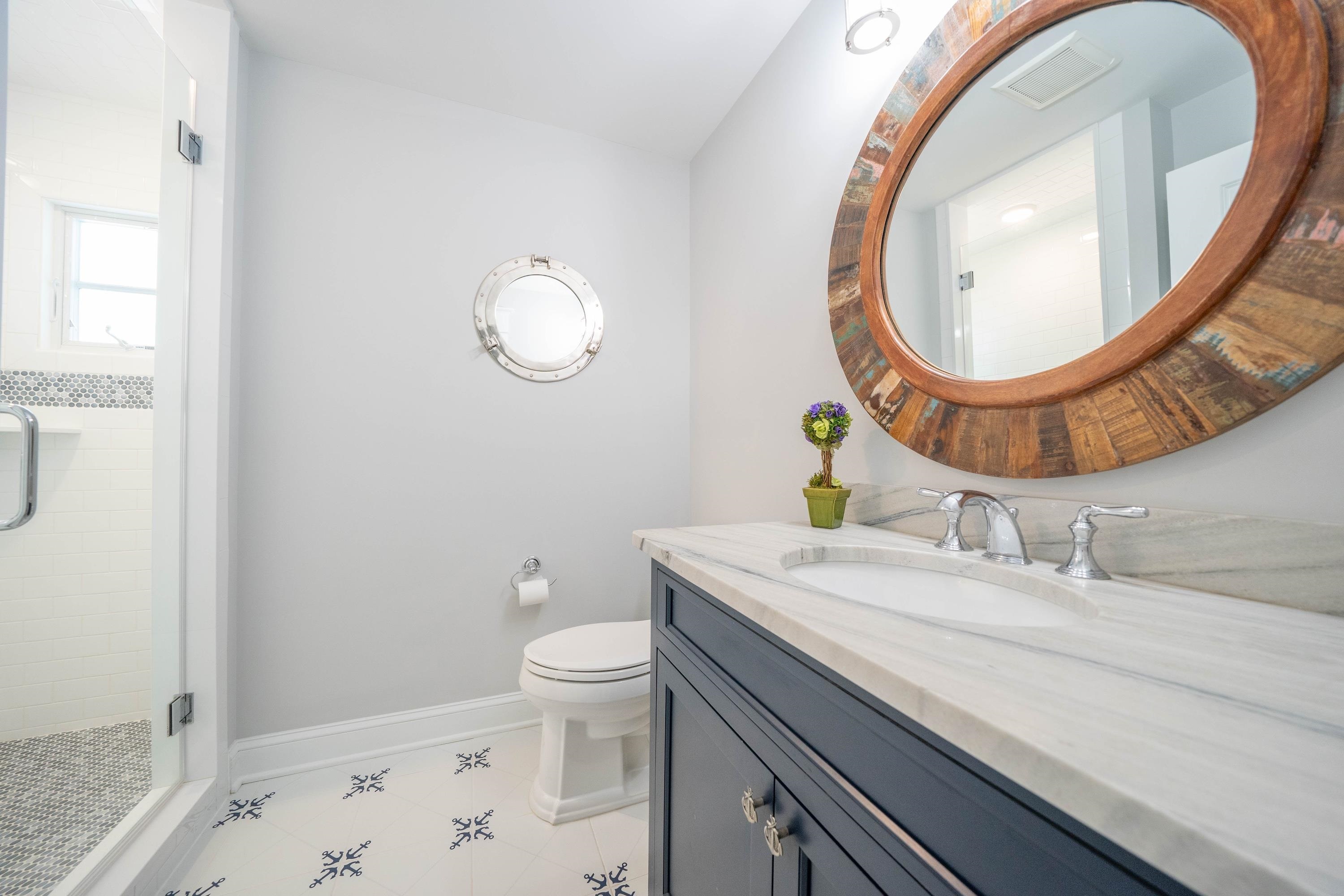 280 36th Avalon, NJ 08202 - Photo 18 of 46 a bathroom with a granite countertop sink a mirror and toilet