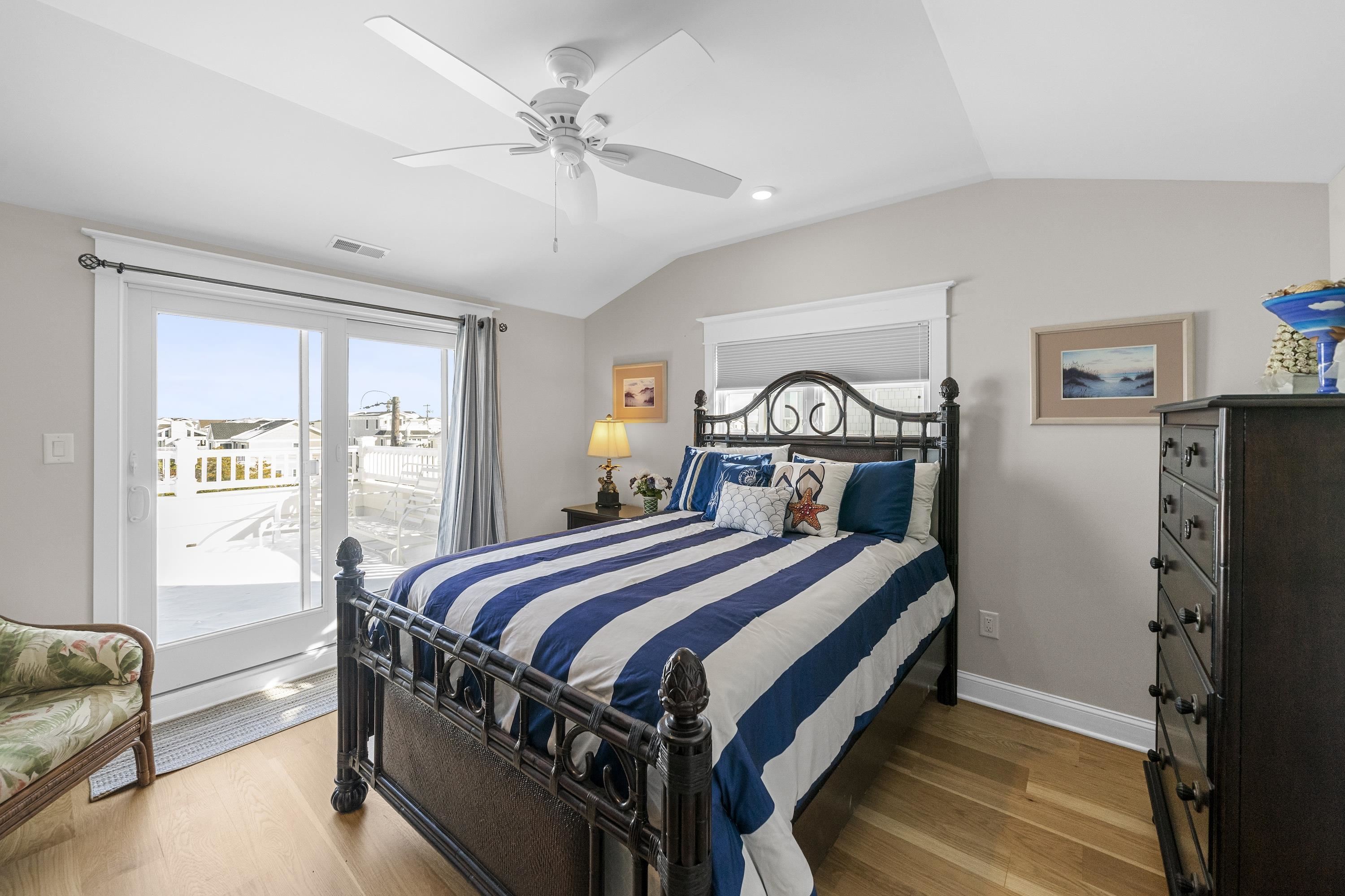 280 36th Avalon, NJ 08202 - Photo 34 of 46 a bedroom with a bed and a chandelier