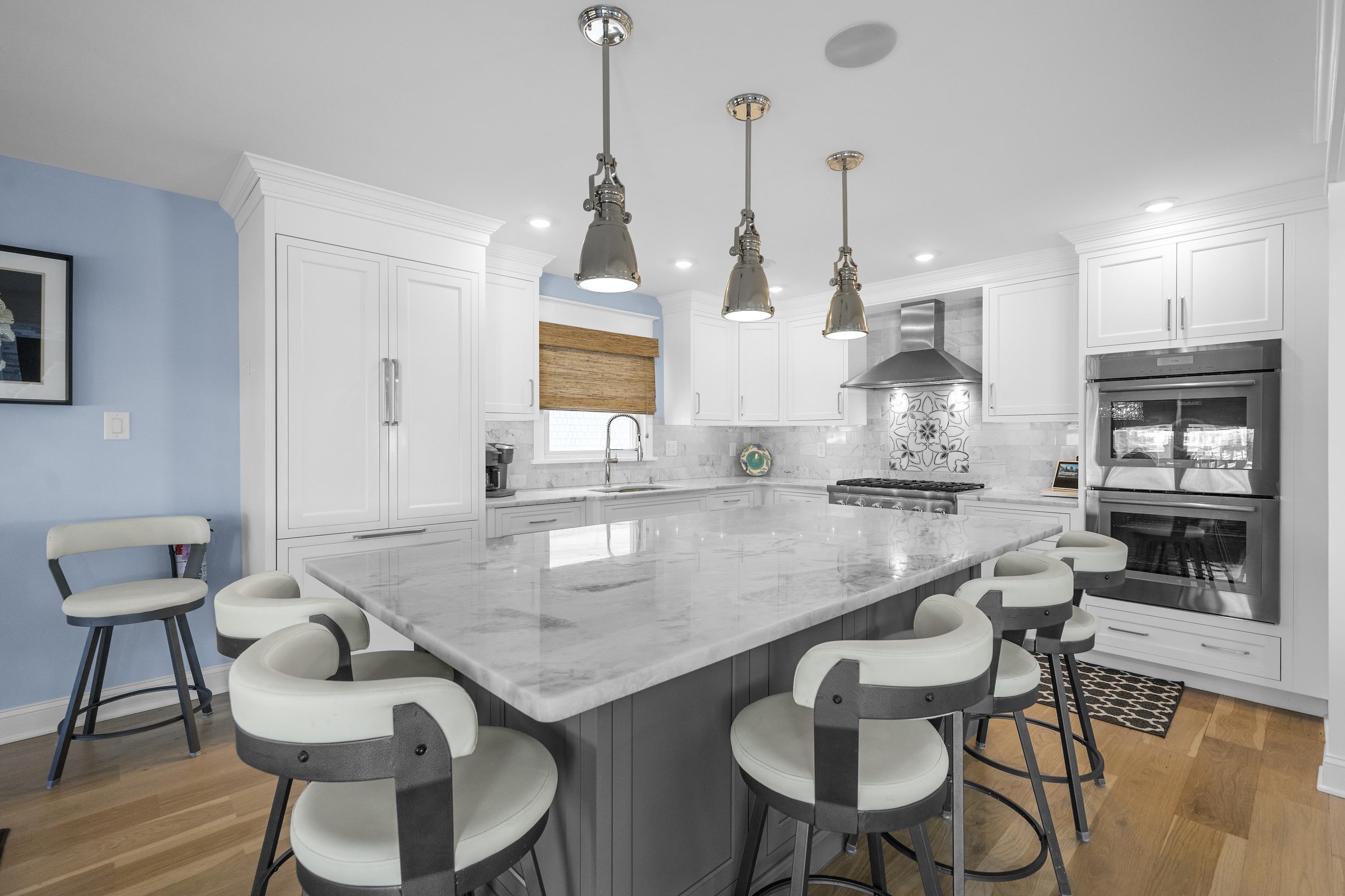 280 36th Avalon, NJ 08202 - Photo 7 of 46 a kitchen with granite countertop kitchen island stainless steel appliances a sink and white cabinets
