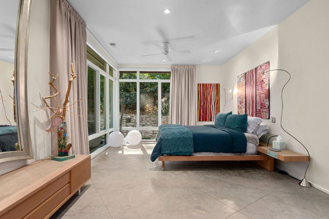 3705 Bridle Path Austin, TX 78703 - Photo 12 of 26 a bedroom with a bed and glass window