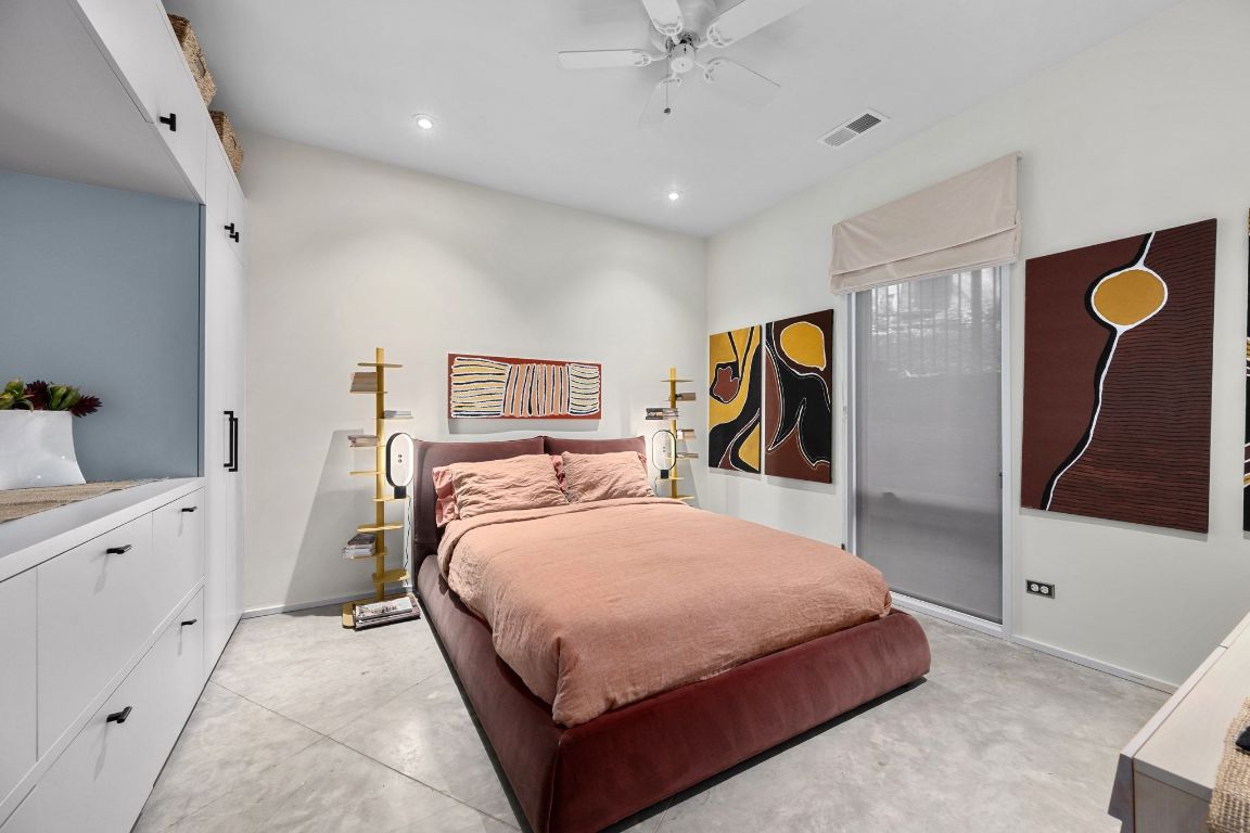 3705 Bridle Path Austin, TX 78703 - Photo 14 of 26 a bedroom with a bed and a refrigerator