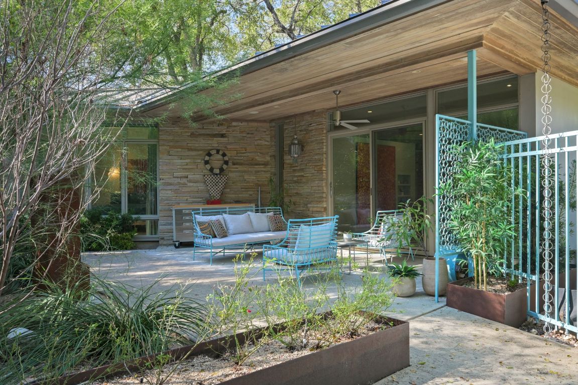 3705 Bridle Path Austin, TX 78703 - Photo 23 of 26 a view of a chair and tables in the patio in front of a house