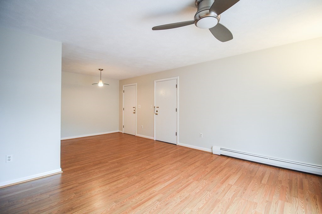 272 Albion Street, Unit 23 Wakefield, MA 01880 - Photo 11 of 33 a view of empty room with wooden floor and fan
