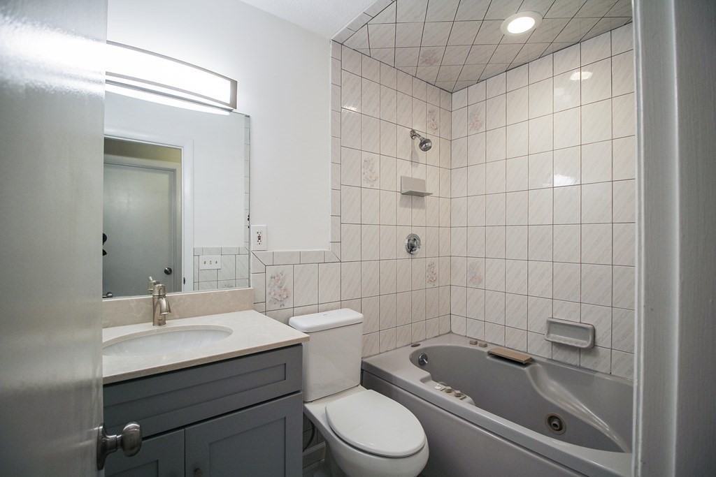 272 Albion Street, Unit 23 Wakefield, MA 01880 - Photo 17 of 33 a bathroom with a sink a toilet and shower