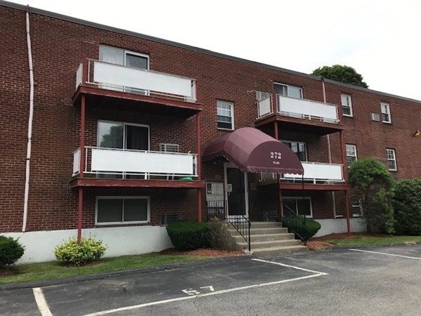 272 Albion Street, Unit 23 Wakefield, MA 01880 - Photo 2 of 33 a front view of a house with garage