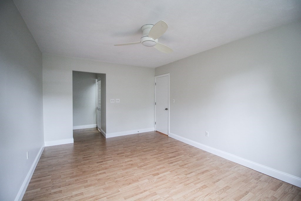 272 Albion Street, Unit 23 Wakefield, MA 01880 - Photo 21 of 33 a view of an empty room with wooden floor